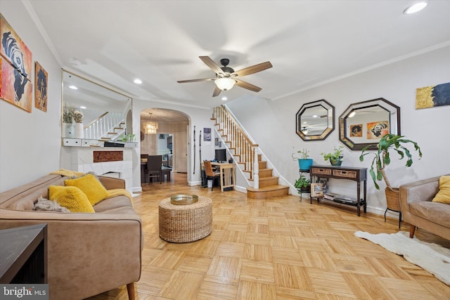 living area with ornamental molding, recessed lighting, arched walkways, baseboards, and stairs