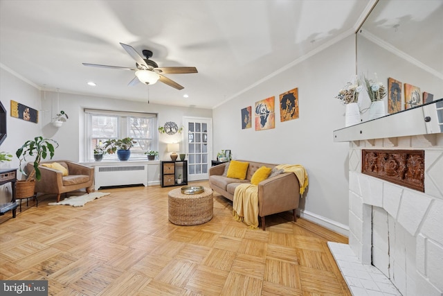 living area featuring ornamental molding, a ceiling fan, radiator heating unit, recessed lighting, and baseboards