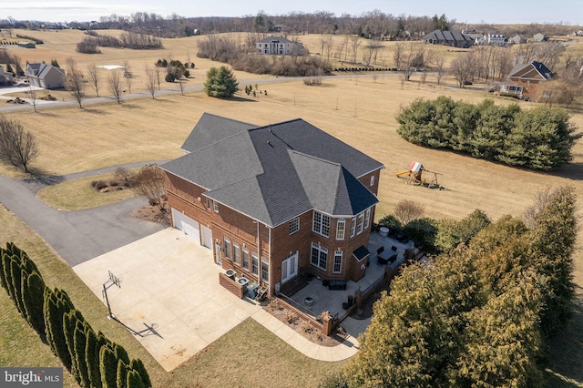 birds eye view of property with a rural view