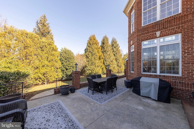 view of patio with outdoor dining space and grilling area