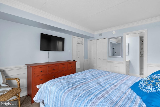 carpeted bedroom featuring a wainscoted wall, a closet, and ornamental molding