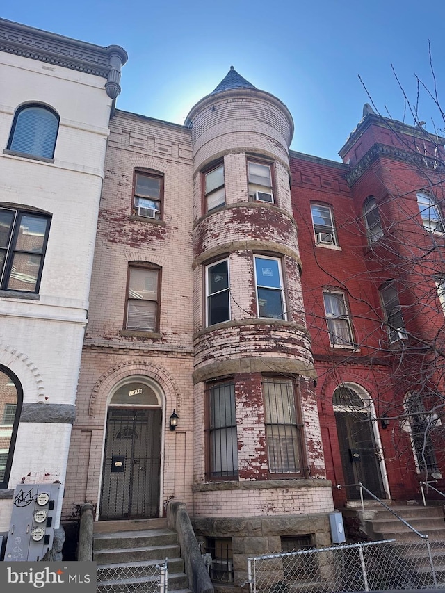 view of building exterior featuring a fenced front yard