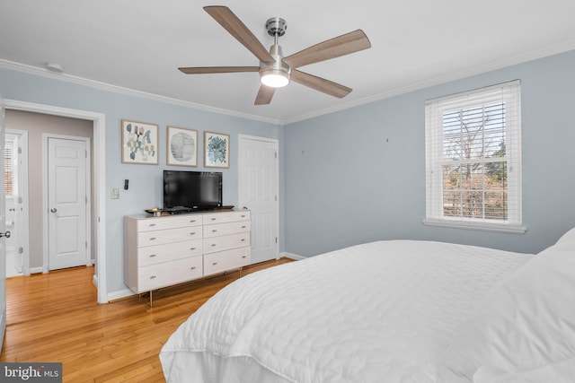 bedroom featuring crown molding, light wood-style flooring, a ceiling fan, and baseboards