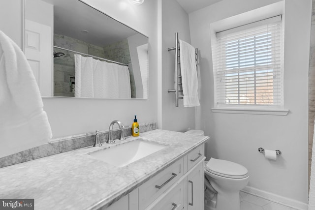 bathroom with vanity, toilet, baseboards, and tiled shower