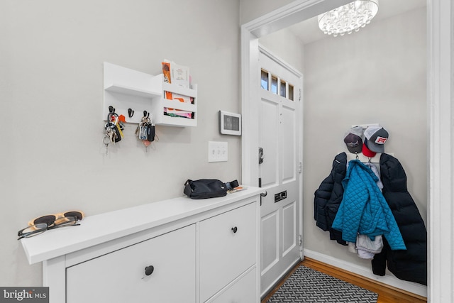 mudroom with wood finished floors and baseboards