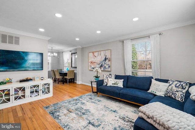 living area with crown molding, hardwood / wood-style flooring, recessed lighting, and visible vents