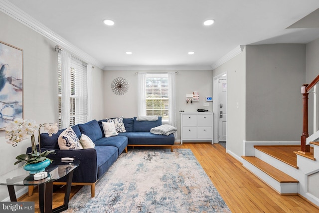 living area featuring stairs, crown molding, and wood finished floors