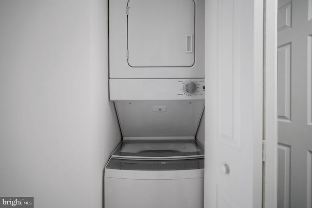 washroom with laundry area and stacked washing maching and dryer