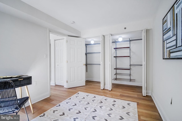 bedroom featuring baseboards and wood finished floors