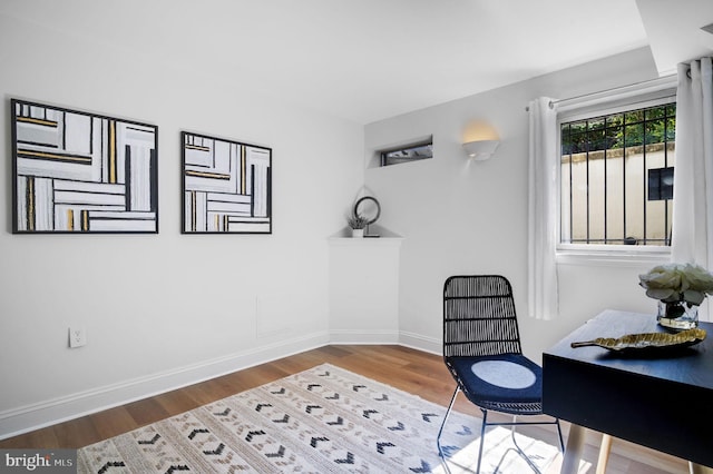 office featuring baseboards and wood finished floors