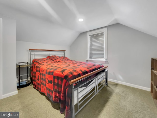 carpeted bedroom with baseboards and vaulted ceiling