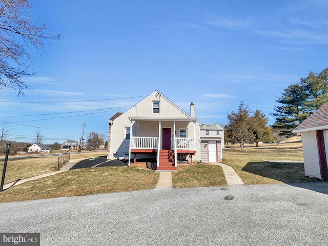 bungalow-style house with covered porch and a front lawn