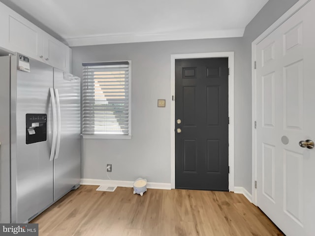 interior space with light wood-style flooring and baseboards