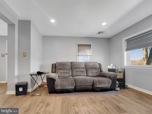 living room with visible vents, recessed lighting, baseboards, and wood finished floors