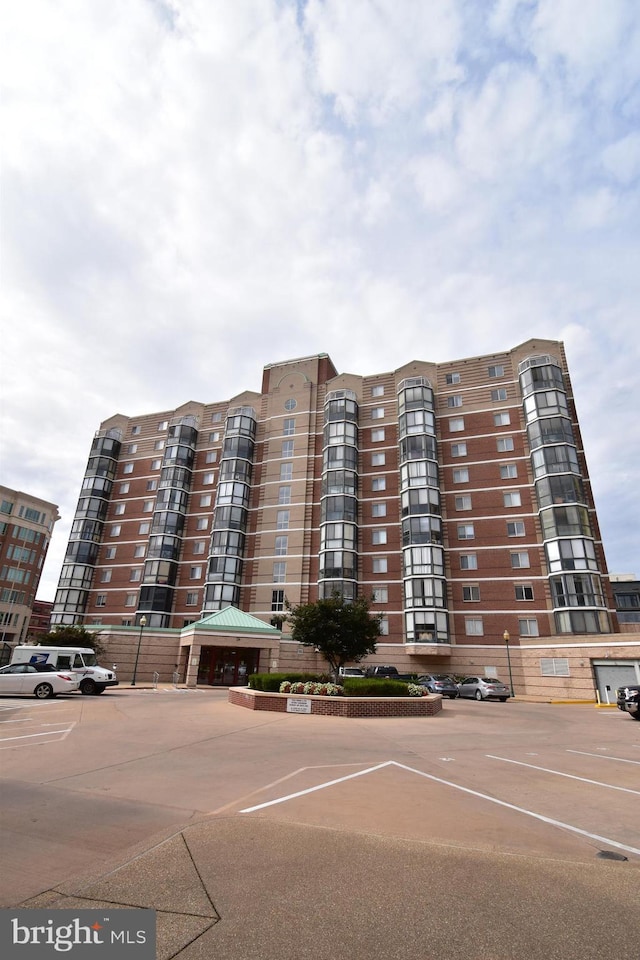 view of building exterior featuring uncovered parking