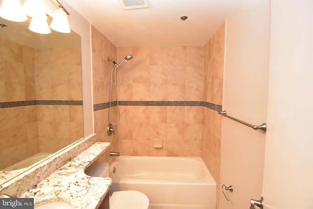 bathroom with visible vents, toilet, bathtub / shower combination, and vanity