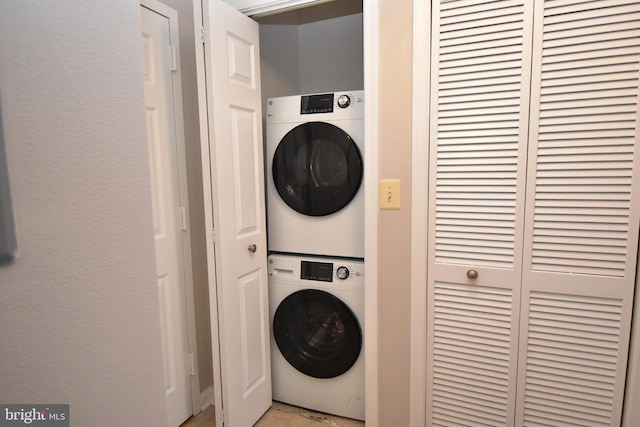 laundry area featuring stacked washer and clothes dryer and laundry area