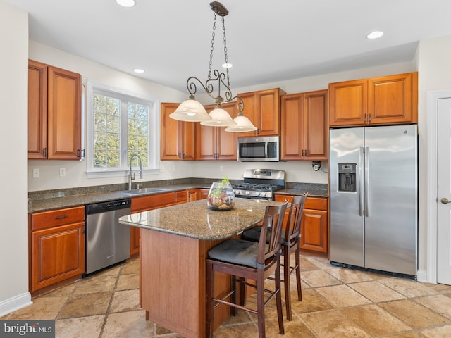 kitchen with recessed lighting, brown cabinets, appliances with stainless steel finishes, and a sink