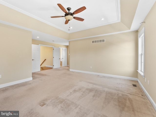 carpeted empty room with visible vents, ceiling fan, and baseboards