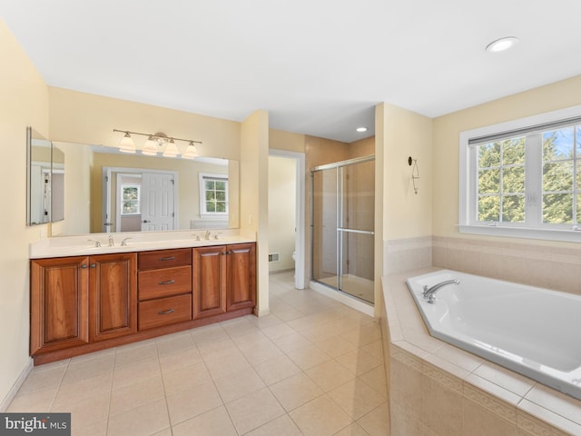 bathroom with toilet, a garden tub, double vanity, a stall shower, and a sink