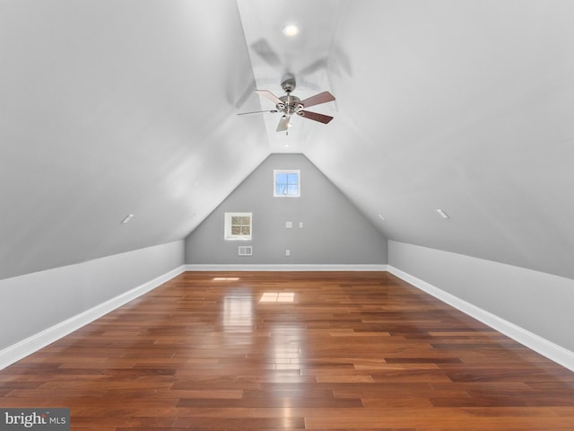 bonus room with wood finished floors, baseboards, and ceiling fan