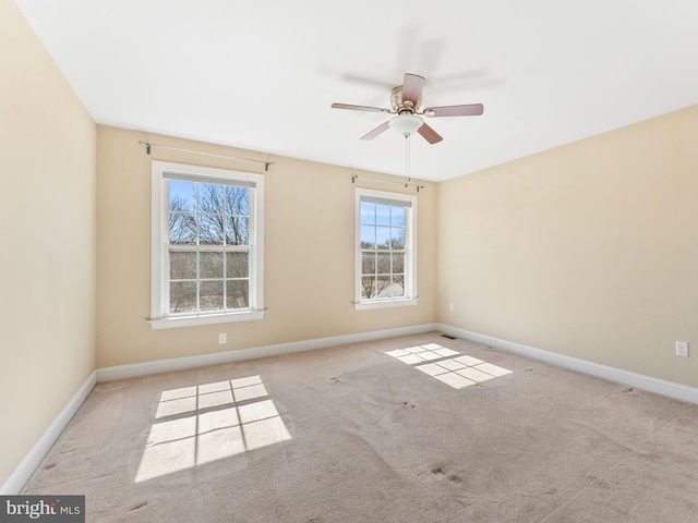 spare room with baseboards, carpet floors, and ceiling fan