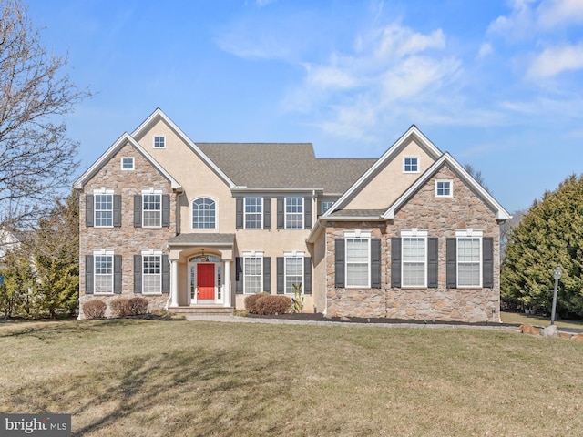 view of front of home featuring stucco siding, stone siding, and a front lawn