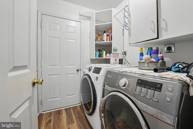 laundry area featuring cabinet space, washer and dryer, and dark wood-style floors