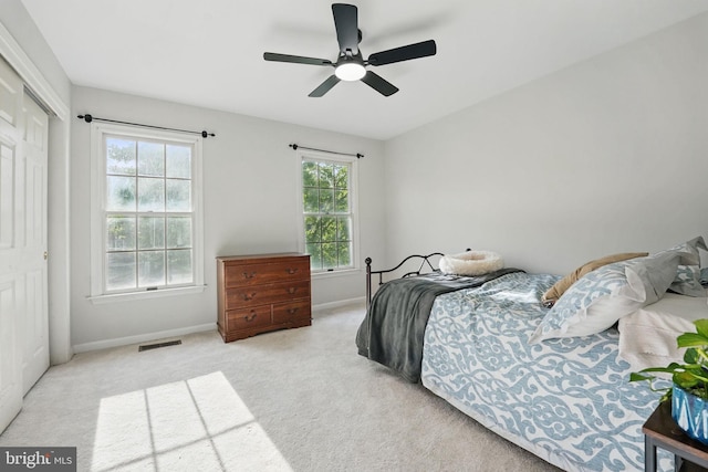 bedroom with a closet, baseboards, carpet flooring, and visible vents
