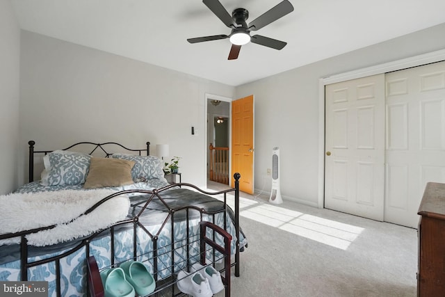 bedroom featuring ceiling fan, light colored carpet, and a closet