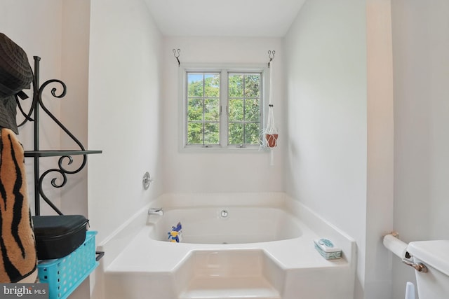 bathroom featuring a bath and toilet