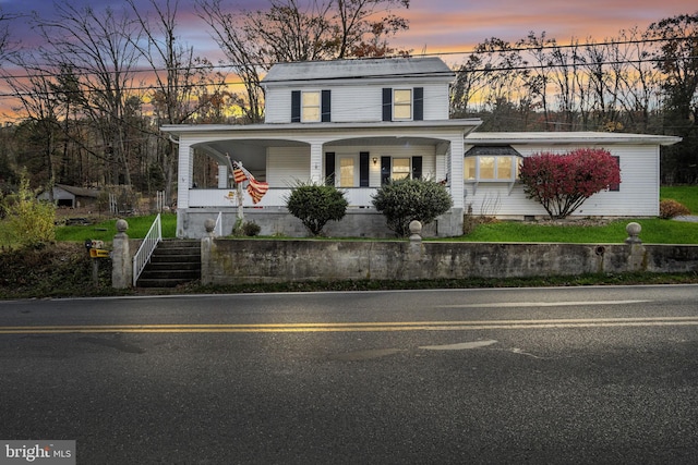 view of front of property with stairway and a porch