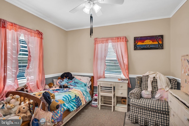 bedroom with carpet, crown molding, and a ceiling fan