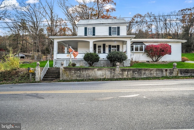 view of front of home with stairway and covered porch