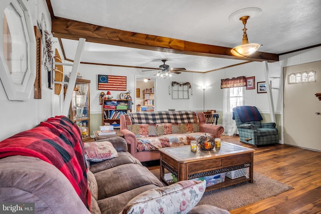 living room featuring beamed ceiling, ceiling fan, and hardwood / wood-style flooring