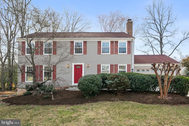 colonial home featuring a front lawn and a chimney