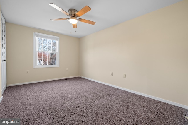 unfurnished room featuring baseboards, carpet floors, and a ceiling fan