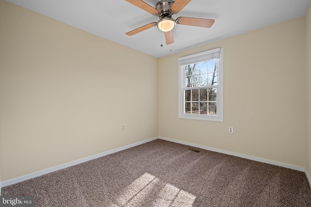 empty room with visible vents, baseboards, carpet, and ceiling fan