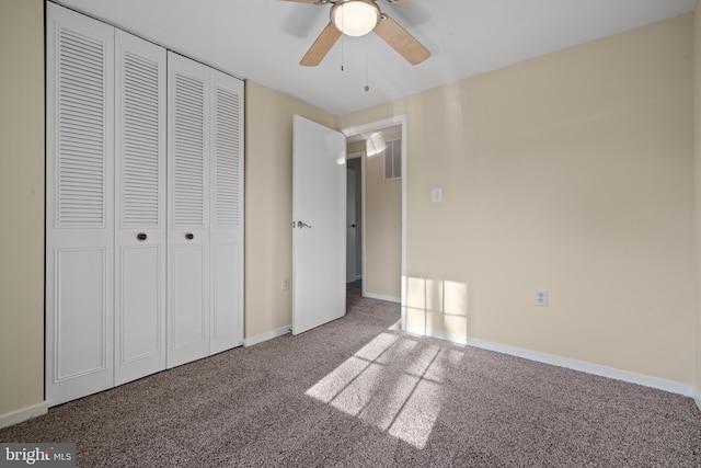 unfurnished bedroom featuring a closet, baseboards, carpet, and a ceiling fan