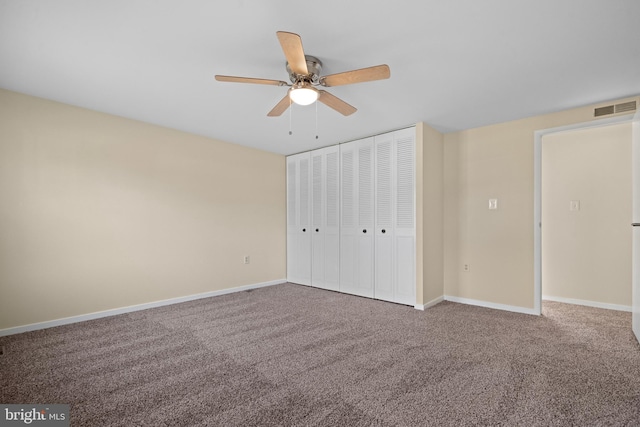 unfurnished bedroom with baseboards, visible vents, ceiling fan, a closet, and carpet flooring