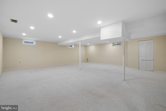 finished below grade area with recessed lighting, visible vents, and light colored carpet