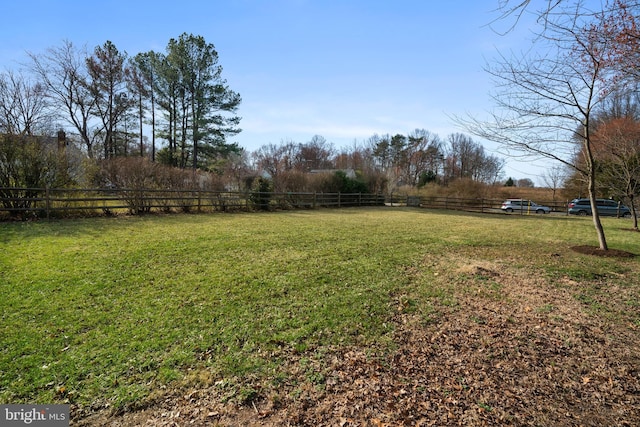 view of yard featuring a rural view and fence