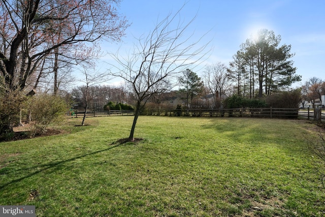 view of yard with a rural view and fence