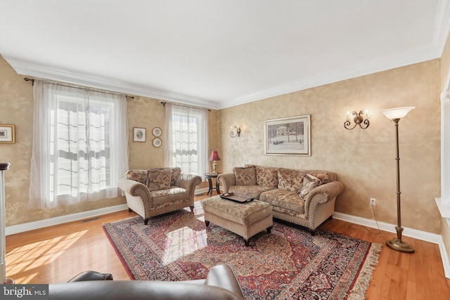 living room featuring crown molding, wood finished floors, visible vents, and baseboards