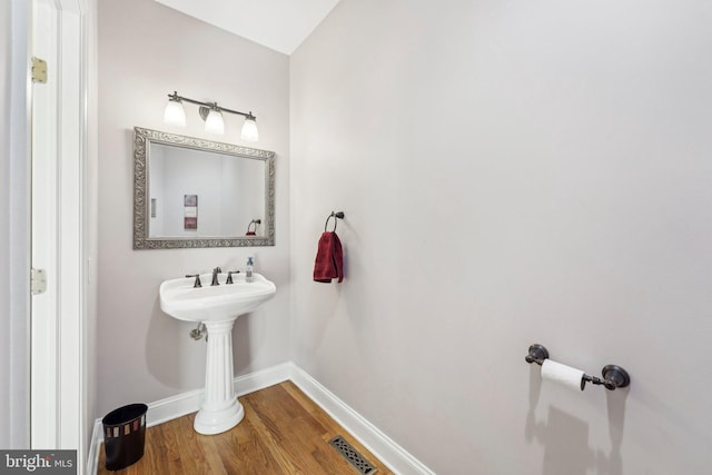 bathroom featuring visible vents, baseboards, and wood finished floors