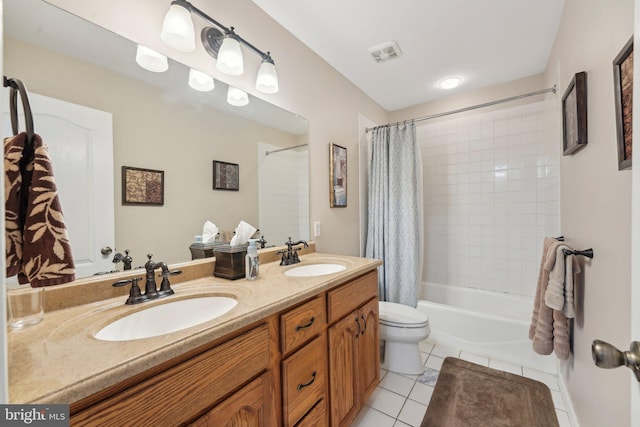 full bath featuring tile patterned floors, visible vents, shower / tub combo with curtain, and a sink