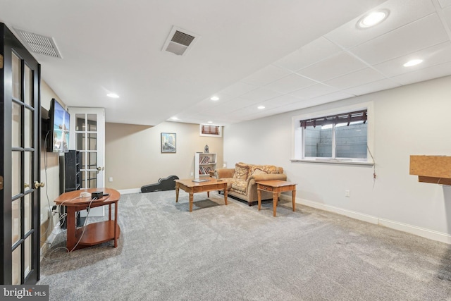 living area featuring carpet, baseboards, and visible vents