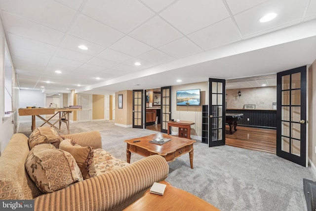 carpeted living room featuring recessed lighting, french doors, a paneled ceiling, and baseboards