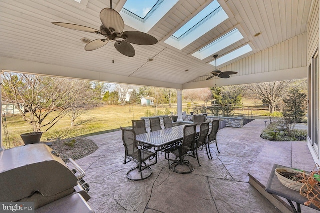 view of patio featuring outdoor dining space, a ceiling fan, and fence