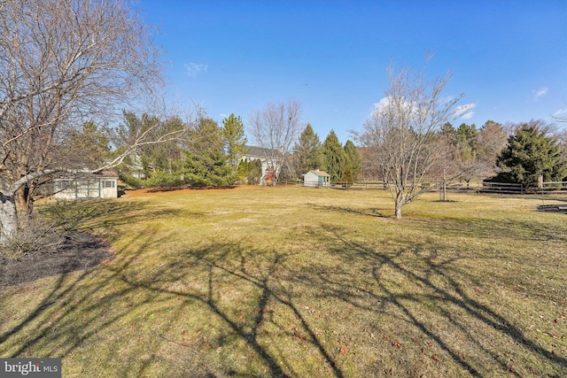 view of yard with an outdoor structure and fence